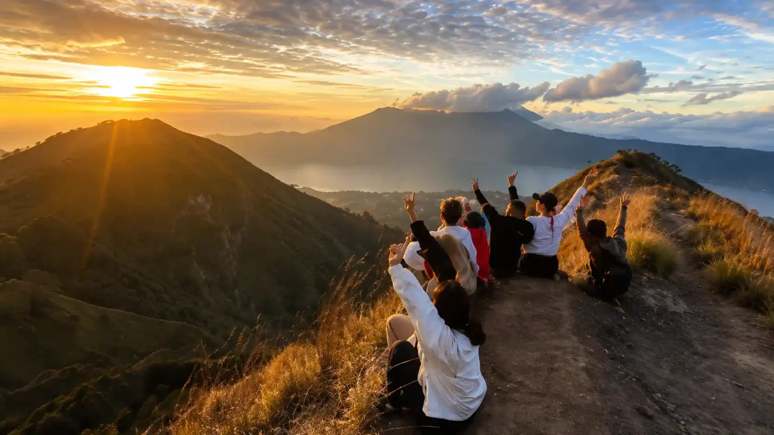 Mount Batur sunrise with cold morning temperature visible from trekkers wearing jackets